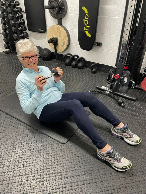 Ann Girling doing sit ups with a weight