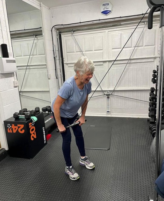 Ann Girling lifting weights in a gym