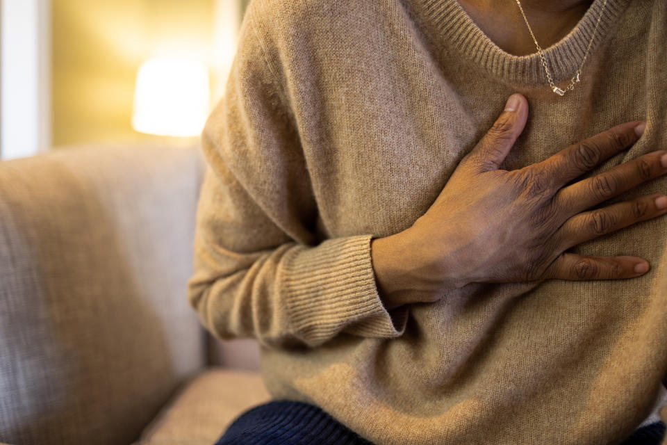 mid adult woman experiencing symptoms of physical pain with hand on chest ~ shot with canon eos R5