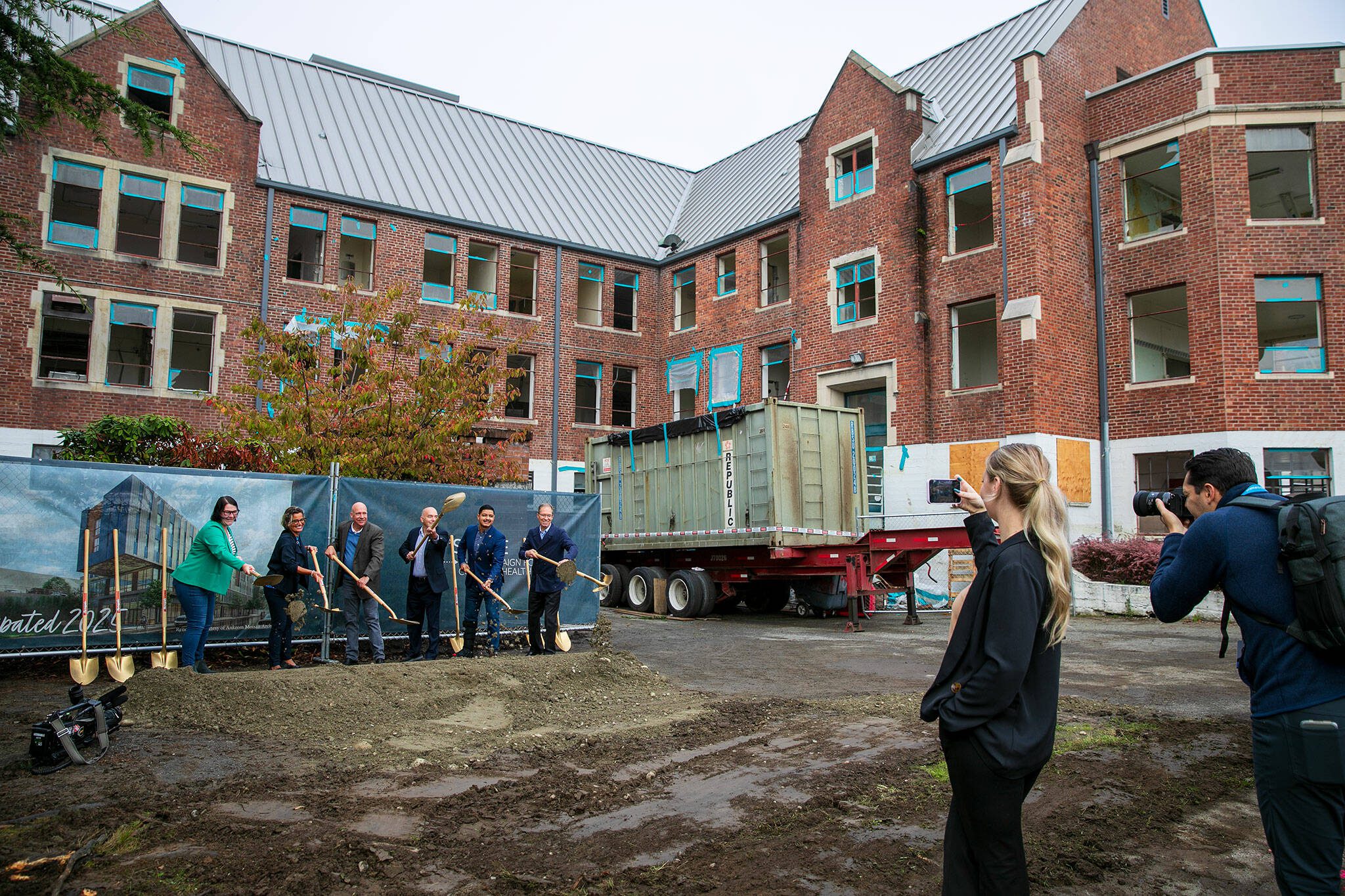 A group including Everett Mayor Cassie Franklin, Compass Health CEO Tom Sebastian, Sen. Keith Wagoner and Rep. Julio Cortes take their turn breaking ground during a ceremony celebrating phase two of Compass Healths Broadway Campus Redevelopment project Thursday, Oct. 12, 2023, in Everett, Washington. (Ryan Berry / The Herald)